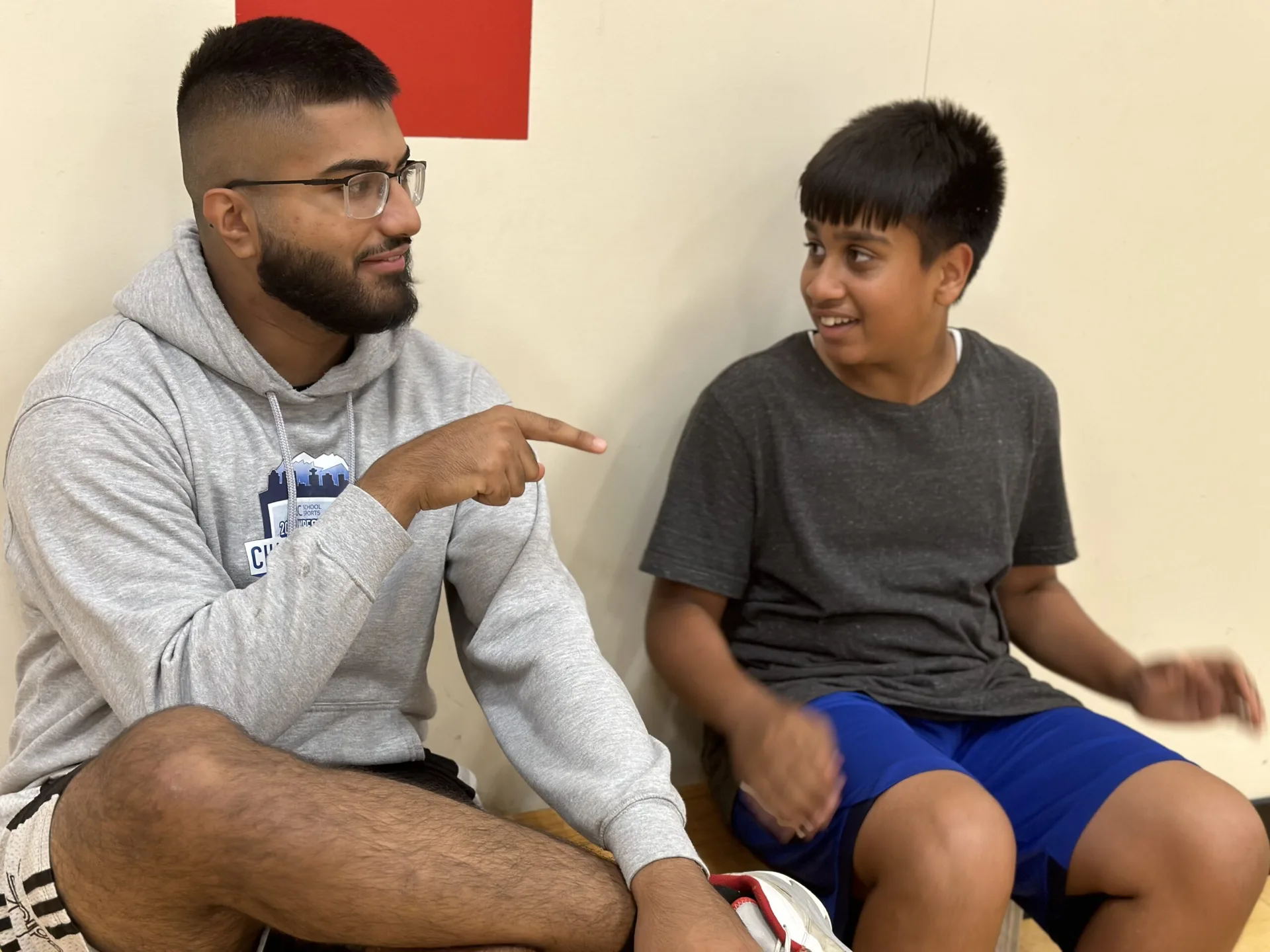 A YBYG mentor speaking with a young program participant