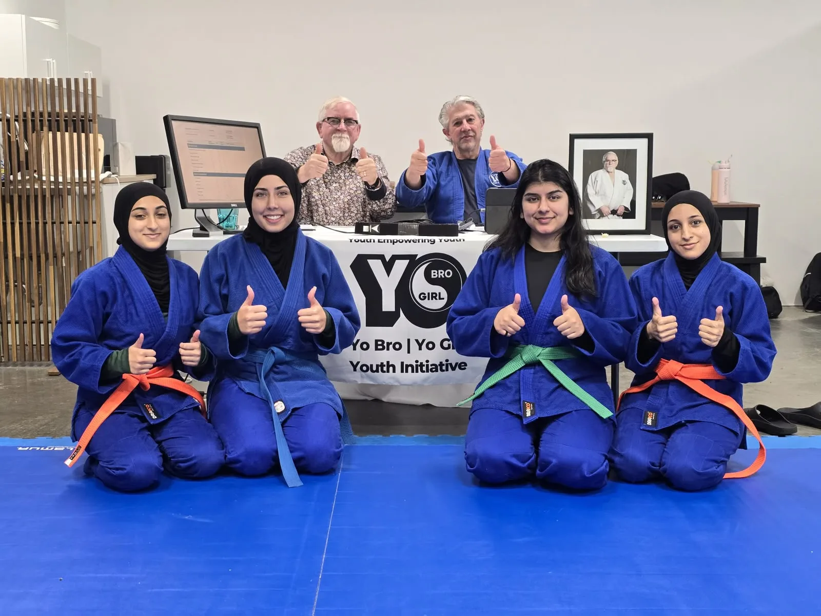 YBYG martial arts participants in blue uniforms with their instructors