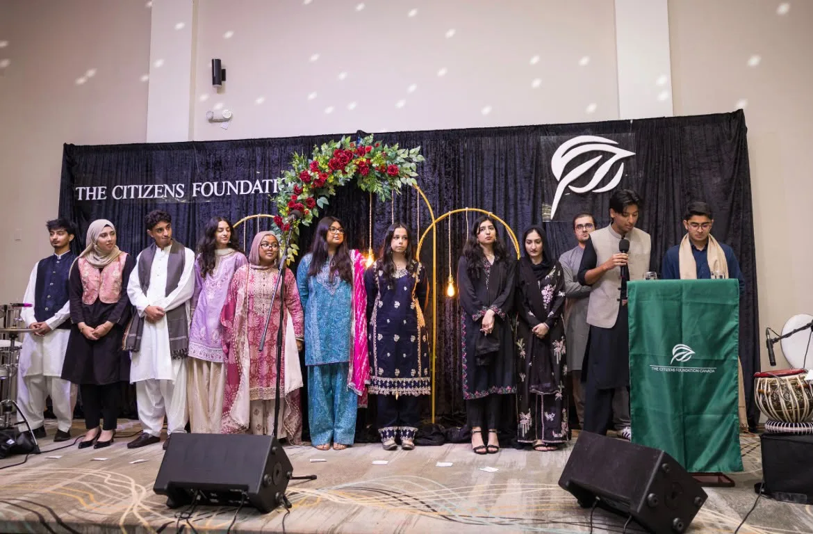 A group on stage at a Citizens Foundation fundraising event