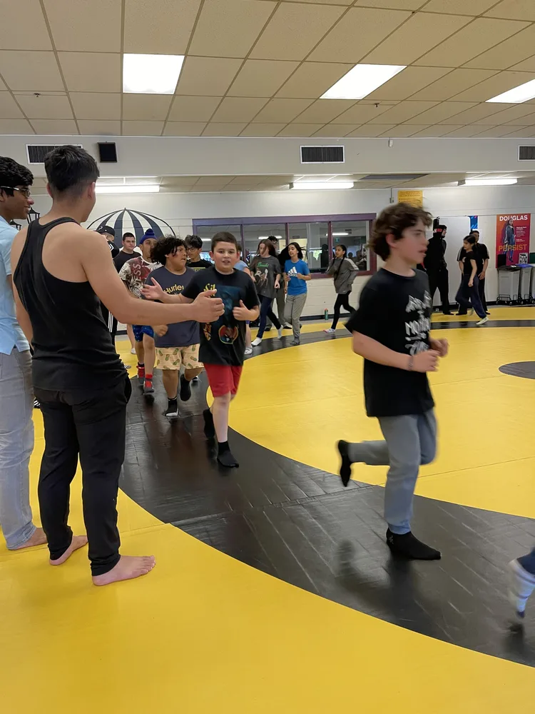 Young students following an instructor during a YBYG martial arts class